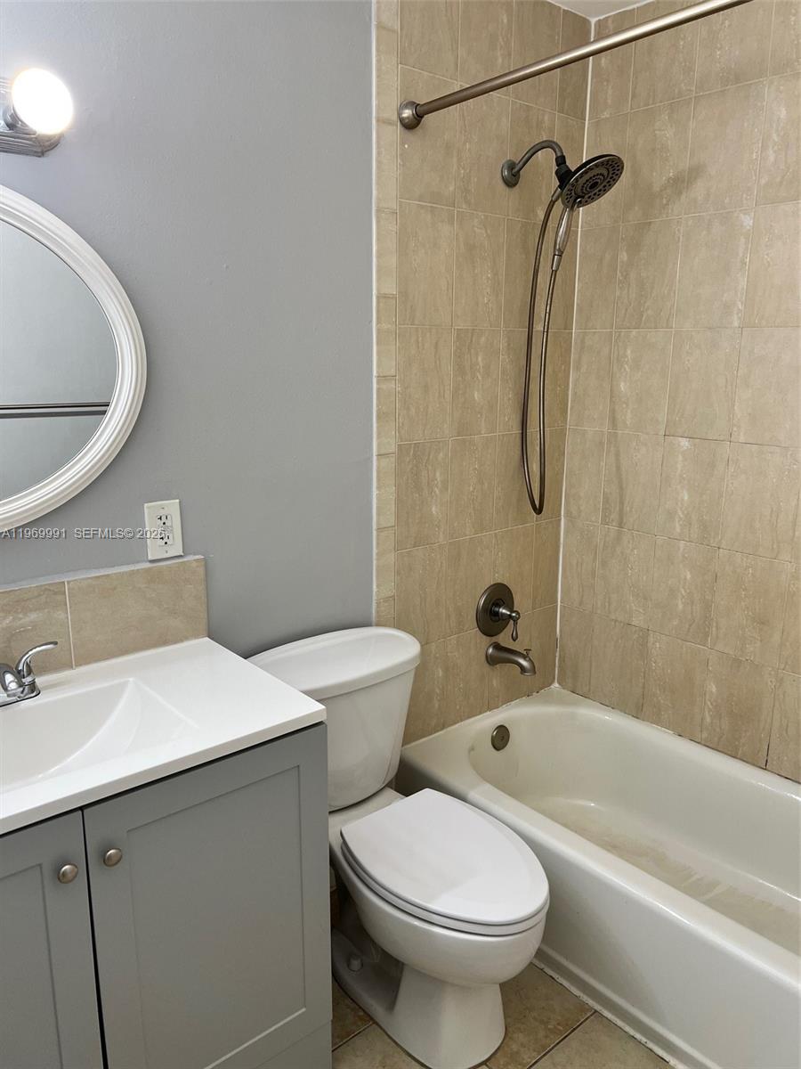 1261 Southwest 46th Avenue, Unit 2003 Pompano Beach, FL 33069 - Photo 6 of 9 a bathroom with a sink a toilet and a bathtub