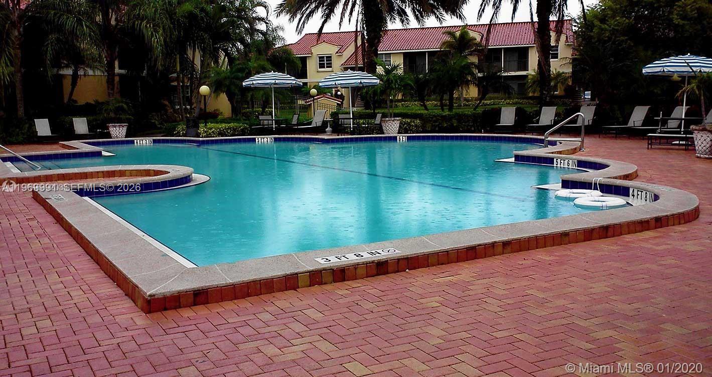 1261 Southwest 46th Avenue, Unit 2004 Pompano Beach, FL 33069 - Photo 8 of 9 an outdoor space with pool and furniture