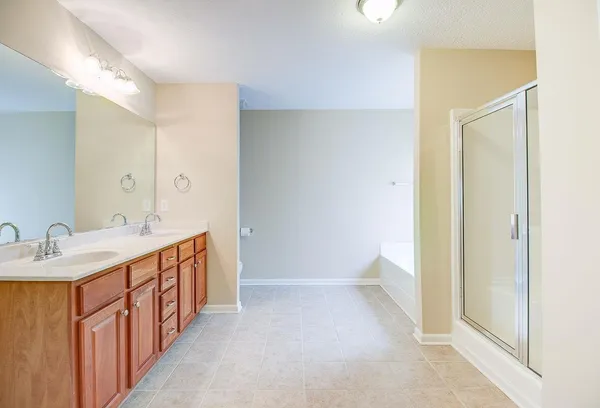 a bathroom with a double vanity sink a toilet and a mirror