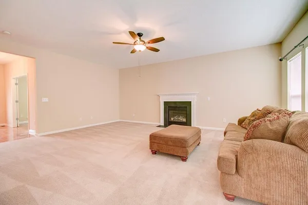 a bedroom with a bed couch and window