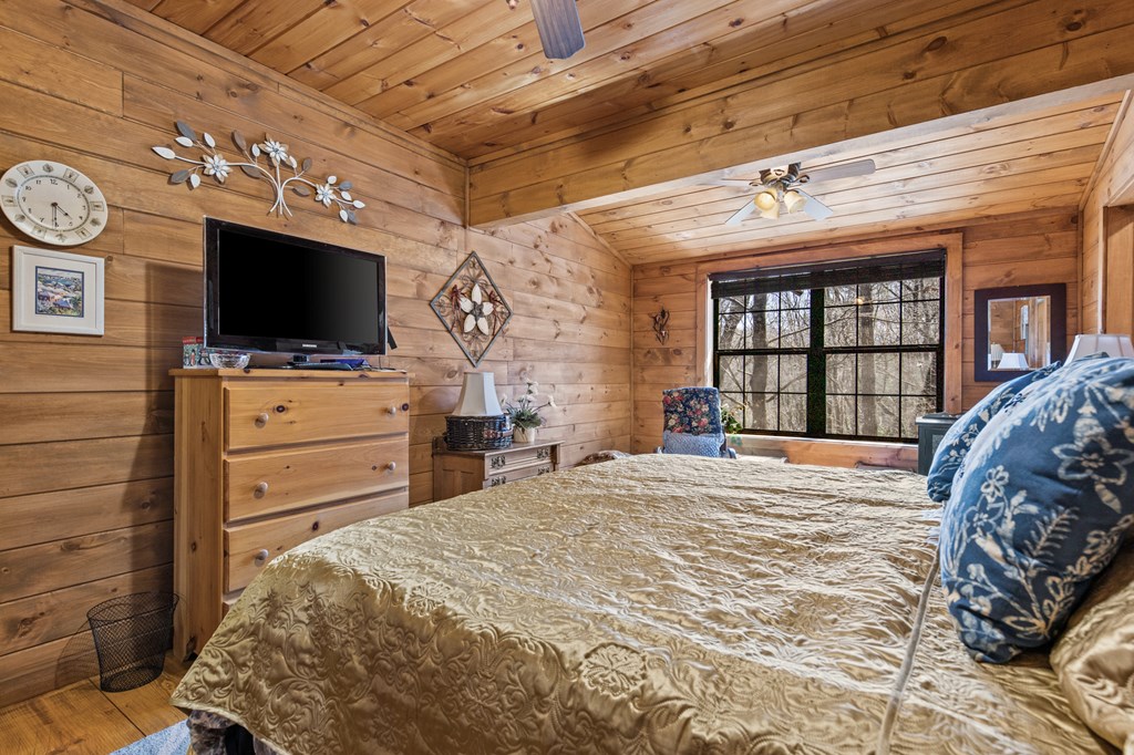 267 Granny Branch Drive Blue Ridge, GA 30513 - Photo 16 of 30 a bedroom with a bed and a flat screen tv