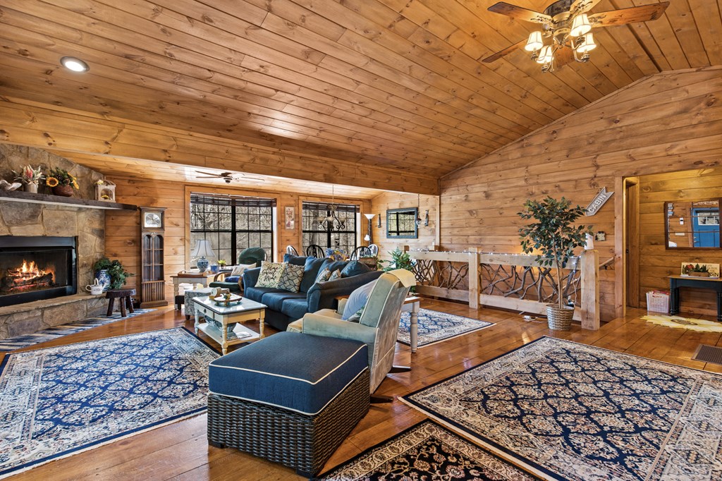 267 Granny Branch Drive Blue Ridge, GA 30513 - Photo 10 of 30 a living room with furniture a rug and a fireplace