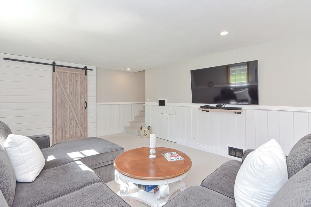 28 Tilden Road Scituate, MA 02066 - Photo 21 of 27 a living room with furniture and a flat screen tv