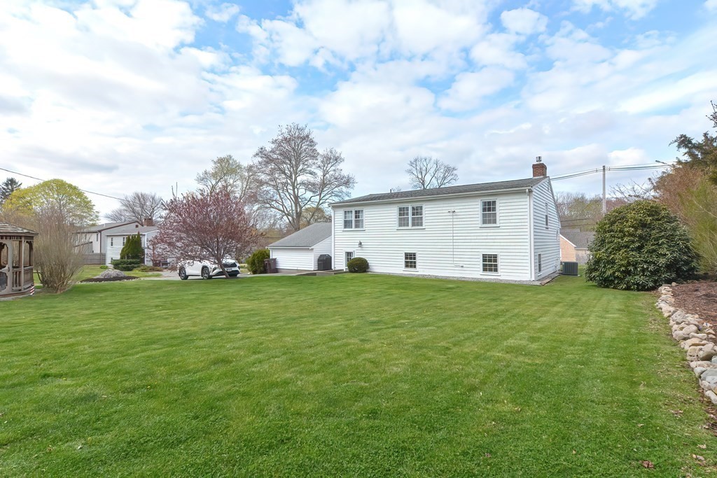 28 Tilden Road Scituate, MA 02066 - Photo 23 of 27 a view of a house with a big yard and a large tree