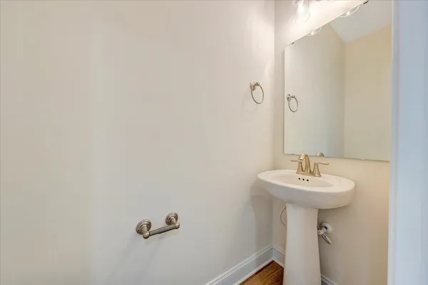 a bathroom with a sink a mirror and a toilet