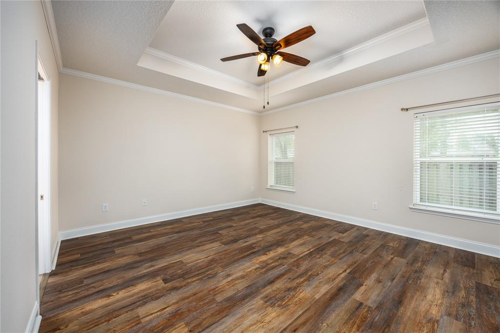 8216 Northwest 54th Street Gainesville, FL 32653 - Photo 34 of 58 an empty room with wooden floor and windows