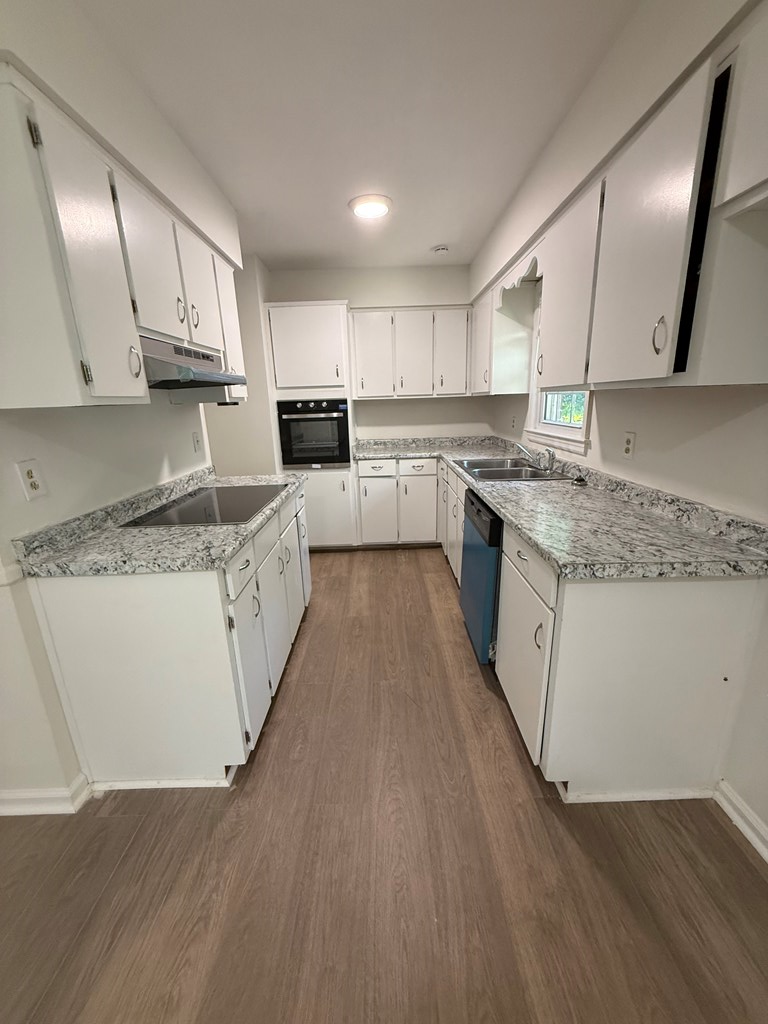 4355 Byron Street Columbus, GA 31907 - Photo 2 of 20 a large kitchen with cabinets wooden floor and stainless steel appliances