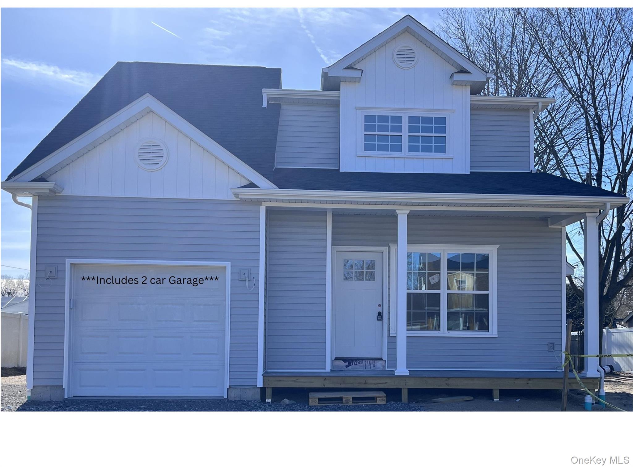 a black and white building with a small yard