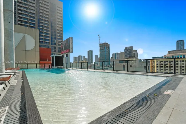 a gym room with lots of gym equipment and glass windows