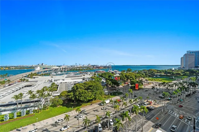a living room with dining room couches and kitchen view
