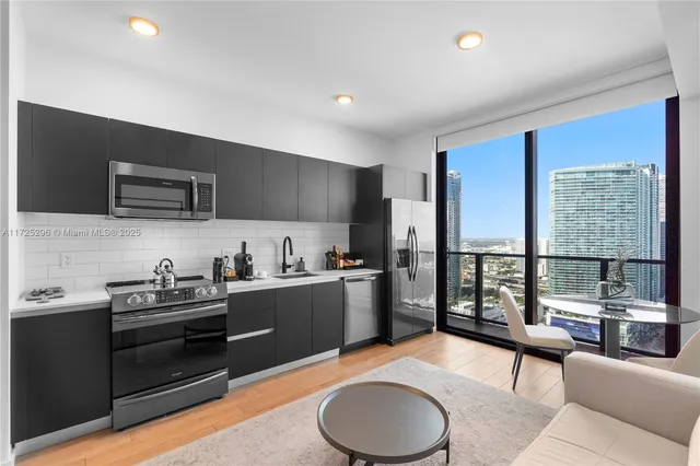 a kitchen with stainless steel appliances a sink stove and refrigerator