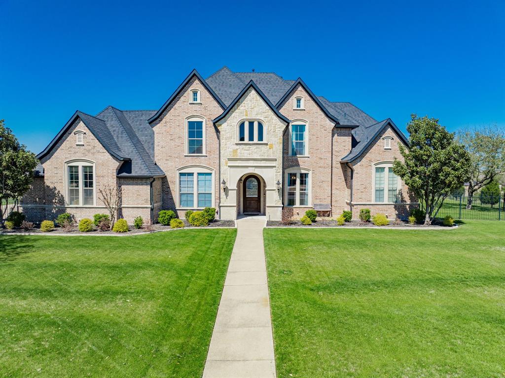 French country style house with brick siding and stone siding