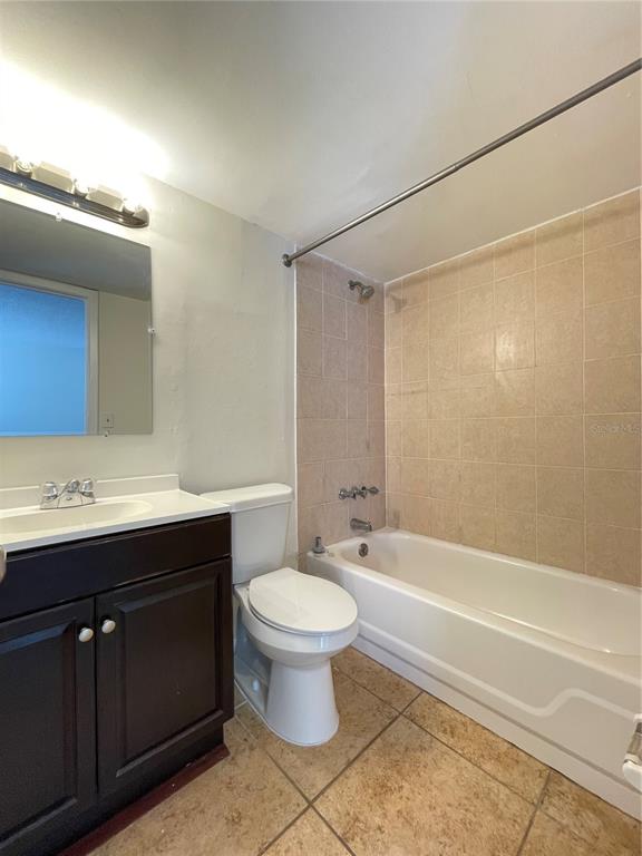 5254 Davisson Avenue, Unit 5254 Orlando, FL 32810 - Photo 12 of 15 a bathroom with a sink a toilet and shower