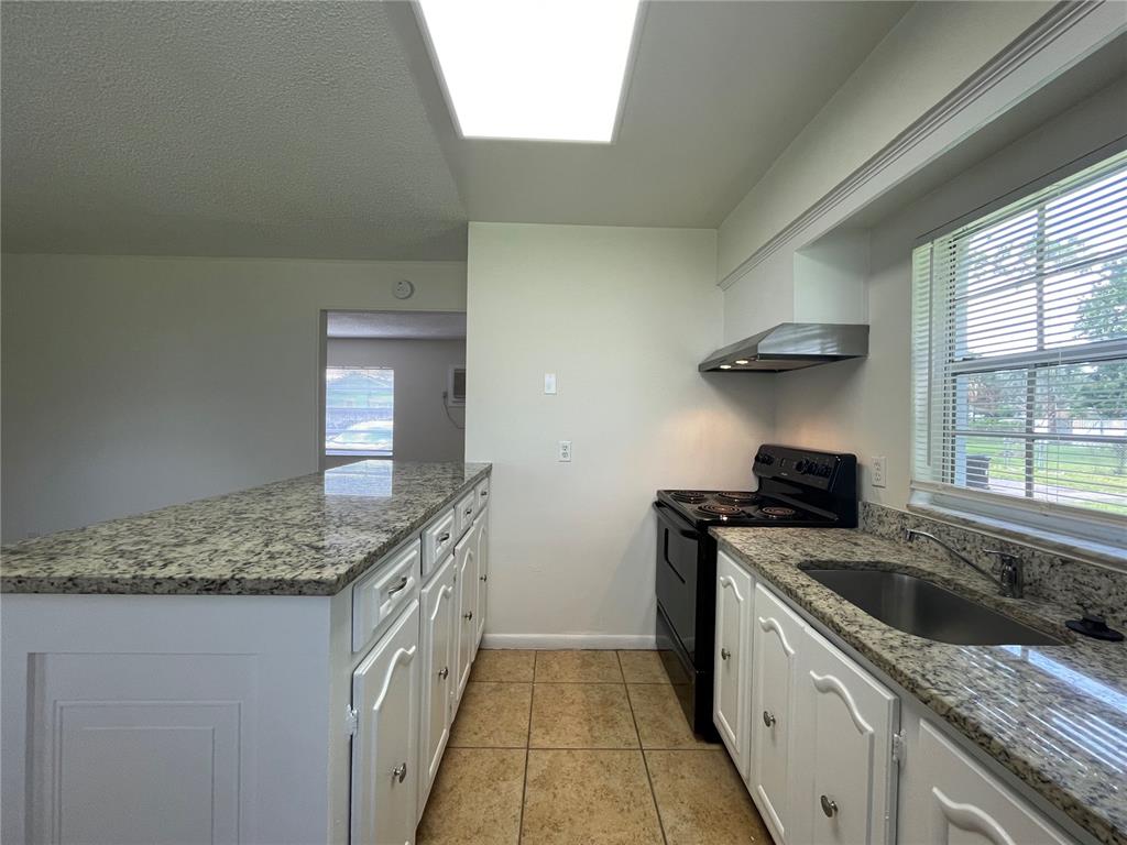 5254 Davisson Avenue, Unit 5254 Orlando, FL 32810 - Photo 5 of 15 a kitchen that has a sink and a stove