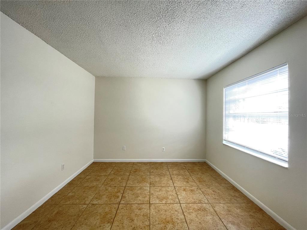 5254 Davisson Avenue, Unit 5254 Orlando, FL 32810 - Photo 7 of 15 an empty room with a window