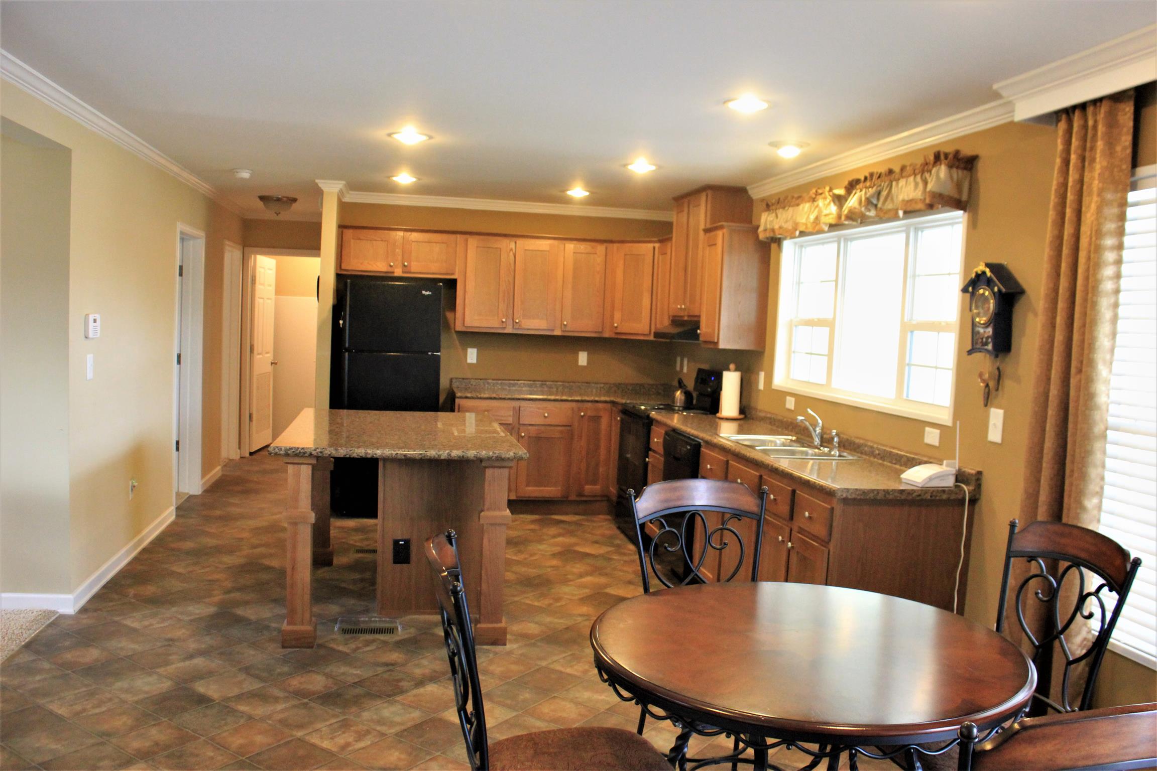 1155 Wrights Mill Road Spring Hill, TN 37174 - Photo 3 of 13 a kitchen with a table chairs refrigerator and cabinets