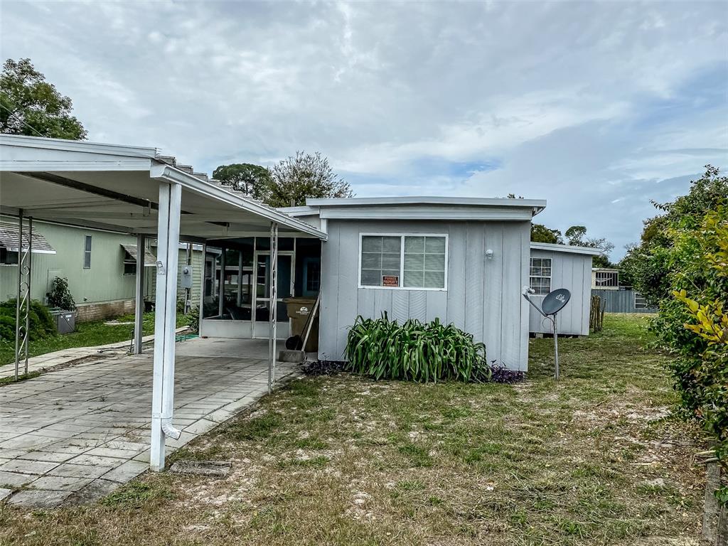 26143 Rose Lane Astatula, FL 34705 - Photo 1 of 1 a front view of a house with garden