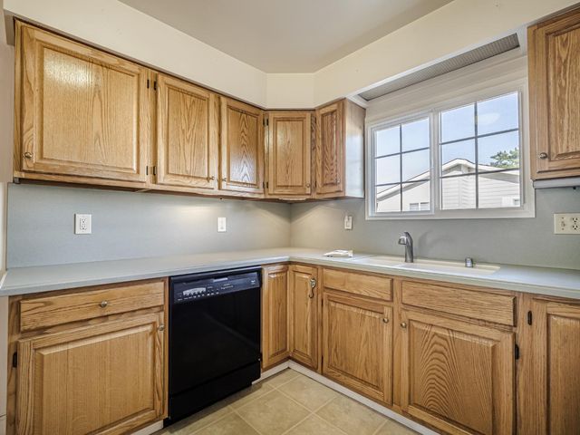 a kitchen with white cabinets and a sink