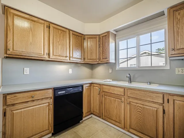 a kitchen with white cabinets and a sink