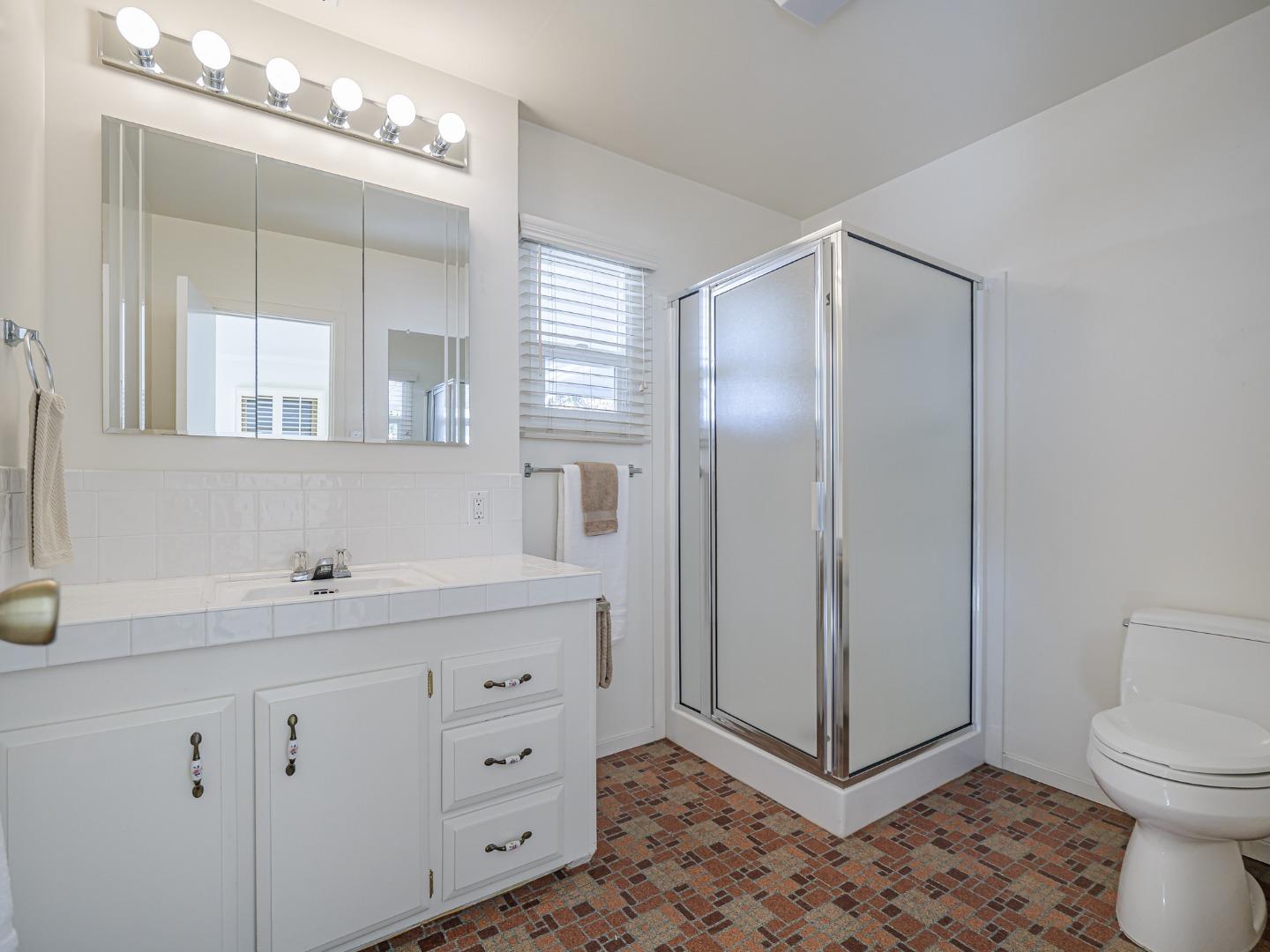225 Mt Hermon Road, Unit 37 Scotts Valley, CA 95066 - Photo 16 of 44 a bathroom with a toilet a sink a mirror and a shower
