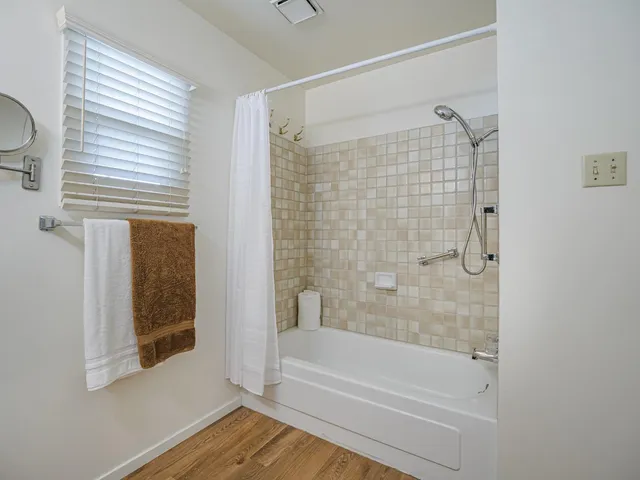 a bathroom with a bathtub and a shower