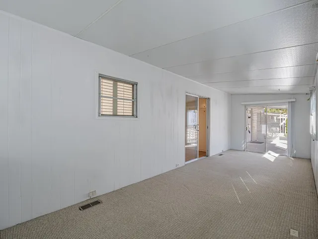 a view of a bedroom with wooden floor and windows