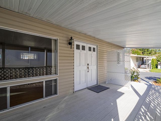 a living room with stainless steel appliances wooden floor and a fireplace