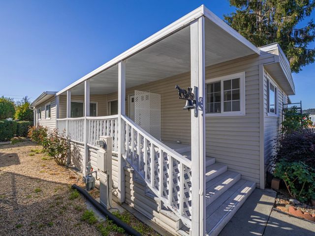 a view of a house with wooden fence