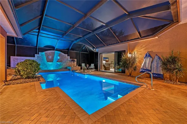 a view of swimming pool with sitting area