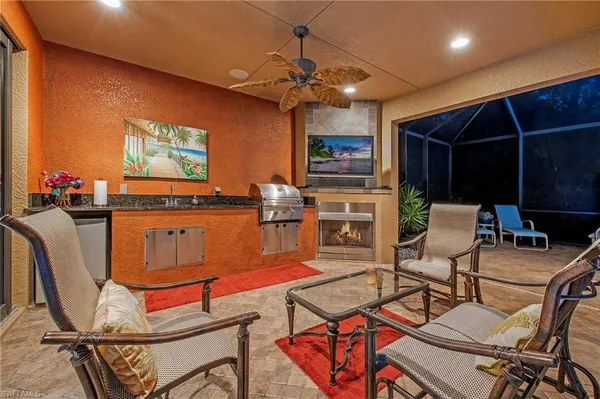 a living room with furniture a flat screen tv and a dining table