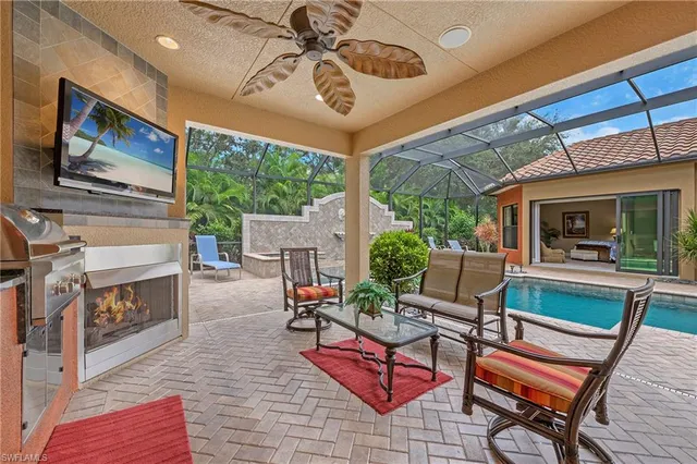 a outdoor living space with furniture and a flat screen tv