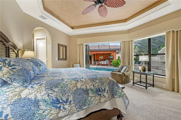 a bedroom with a bed and a large mirror on the dresser