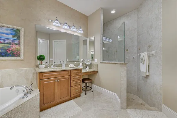 a spacious bathroom with a granite countertop sink a toilet a mirror and shower