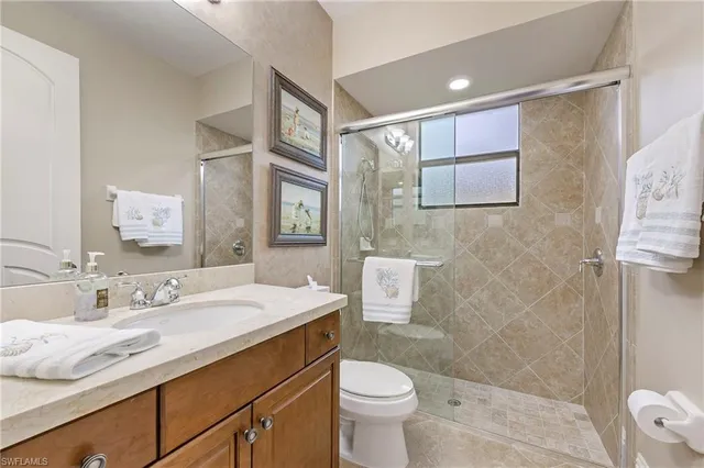 a bathroom with a sink toilet a mirror and shower