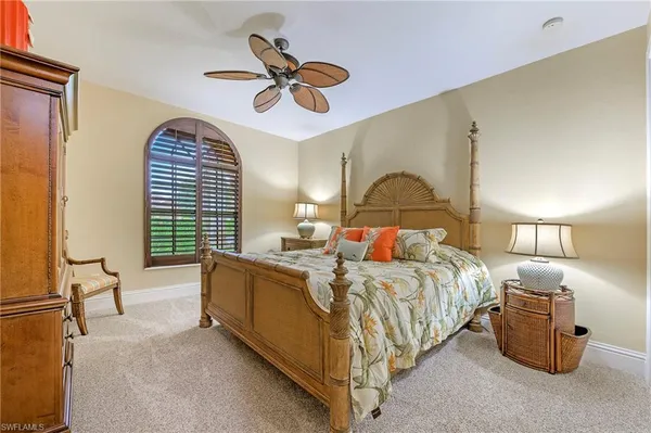 a bed room with a bed and a chandelier