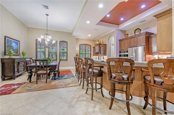 a view of a dining room with furniture and chandelier
