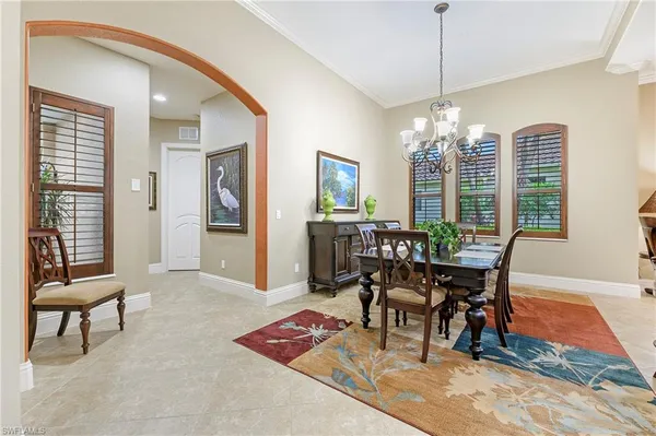 a view of a dining room with furniture and chandelier