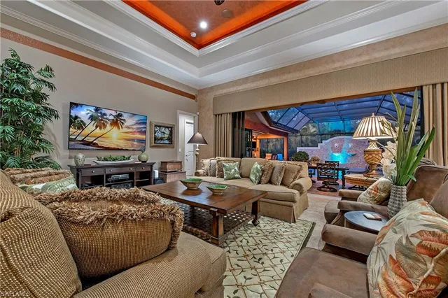a living room with furniture a rug and a flat screen tv