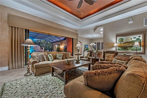 a living room with furniture and a chandelier