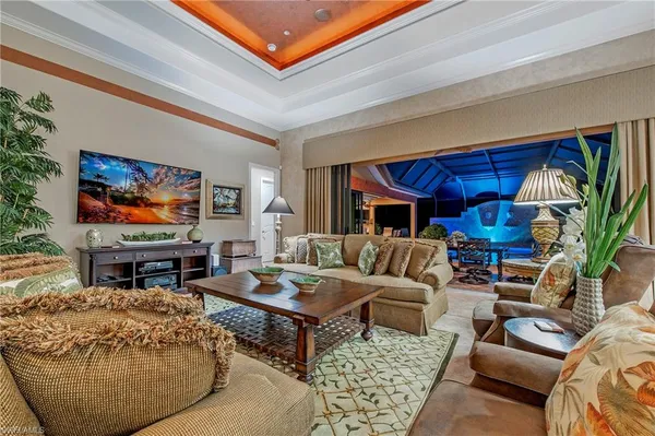 a living room with furniture a rug and a flat screen tv