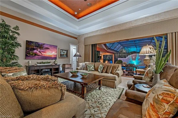 a living room with furniture a rug and a flat screen tv