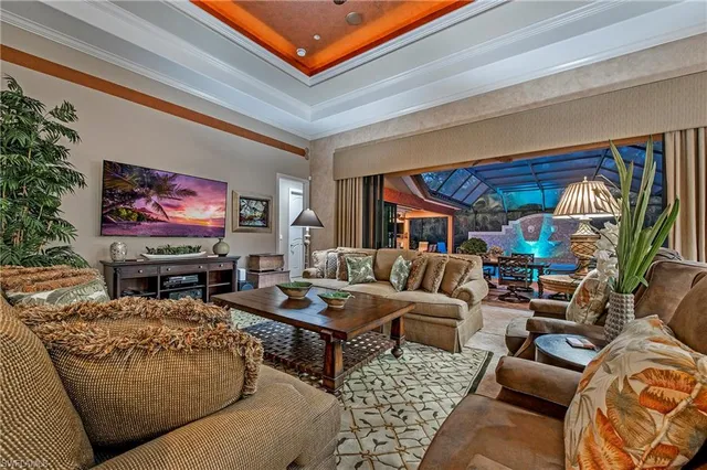 a living room with furniture a rug and a flat screen tv