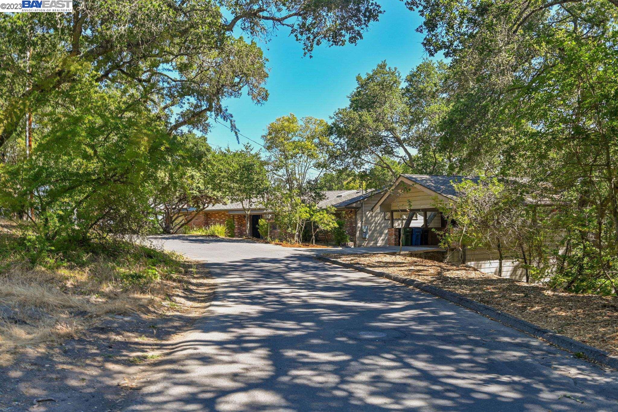 Undisclosed Address Orinda, CA 94563 - Photo 1 of 32 a front view of a house with a yard and trees