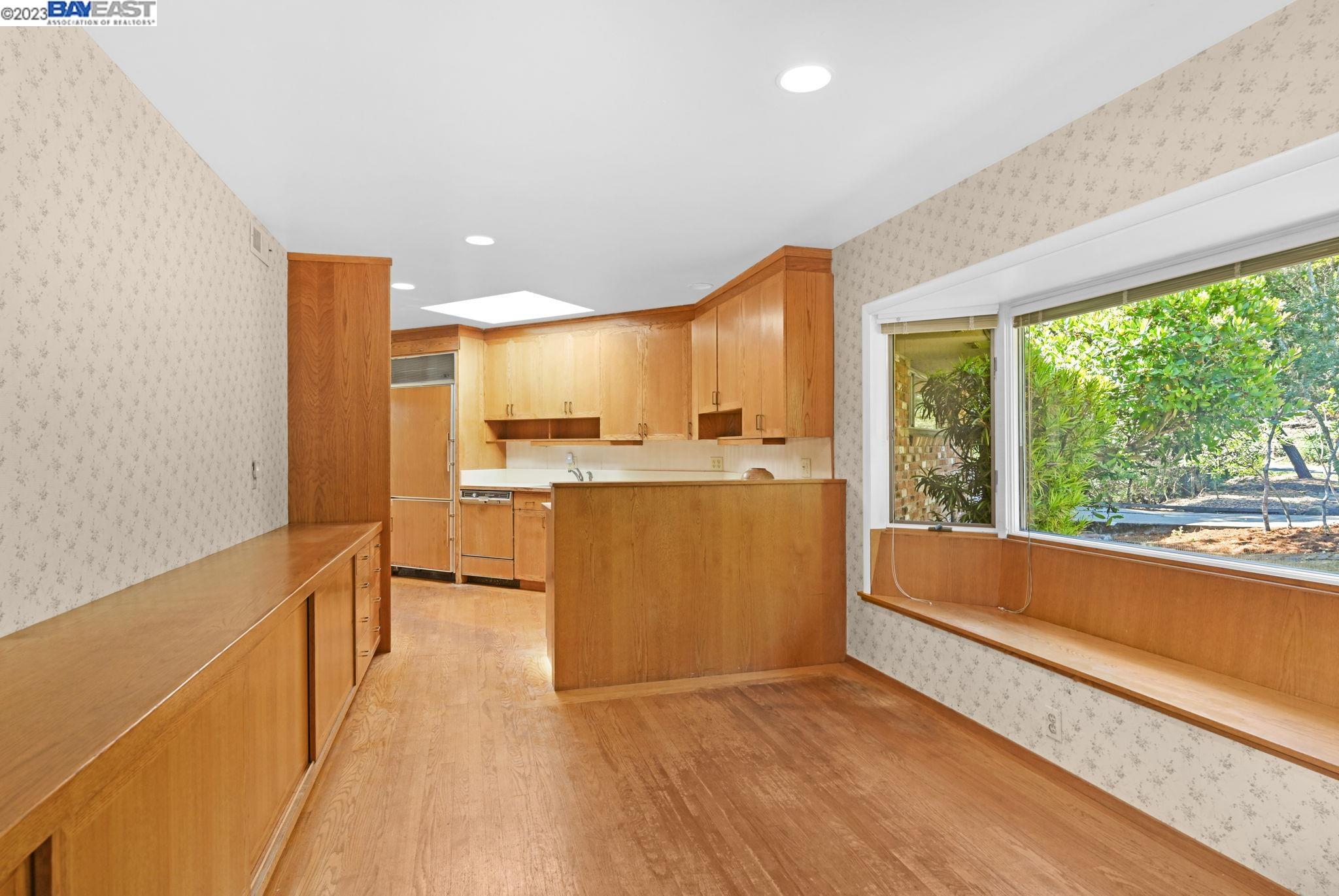 Undisclosed Address Orinda, CA 94563 - Photo 9 of 32 a view of kitchen with kitchen island a sink wooden floor and a large window