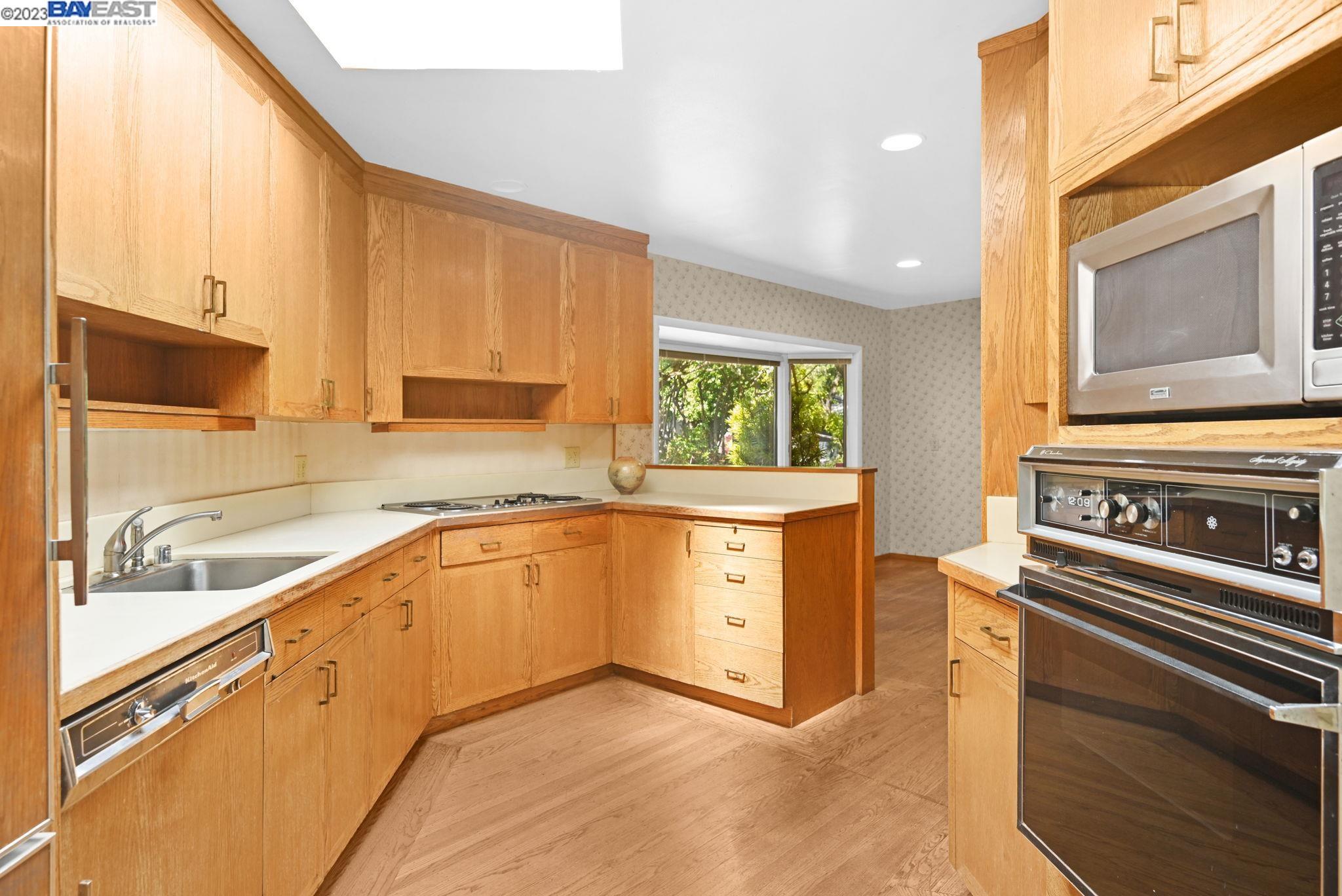 Undisclosed Address Orinda, CA 94563 - Photo 10 of 32 a kitchen with granite countertop a stove a sink and a microwave
