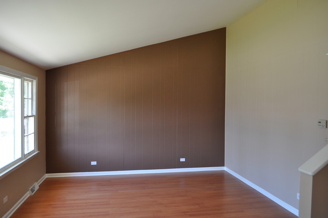 1413 Ridgeway Street Round Lake Beach, IL 60073 - Photo 3 of 16 a view of an empty room with wooden floor and a window