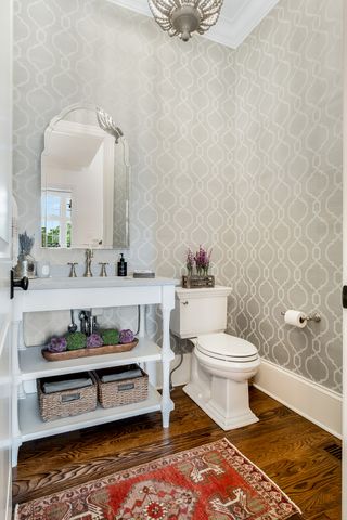a living room with furniture wooden floor and a large window