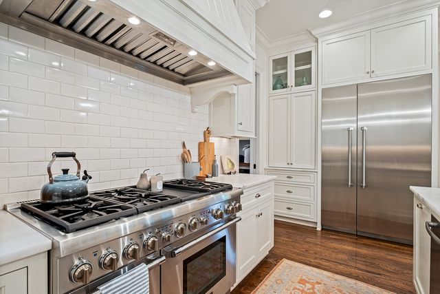 a spacious bathroom with a double vanity sink a mirror and a shower