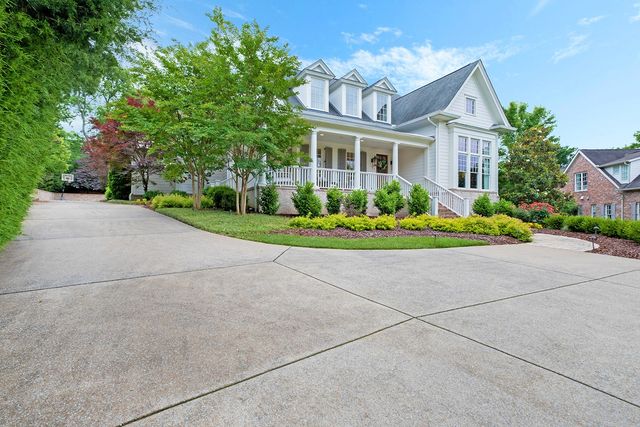 a front view of a house with a yard and potted plants