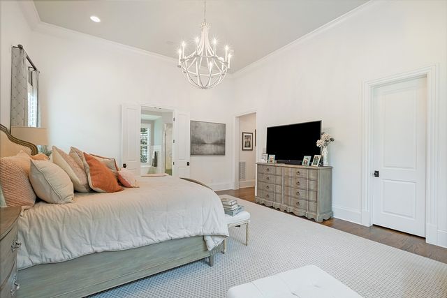 a living room with furniture flat screen tv and a large window